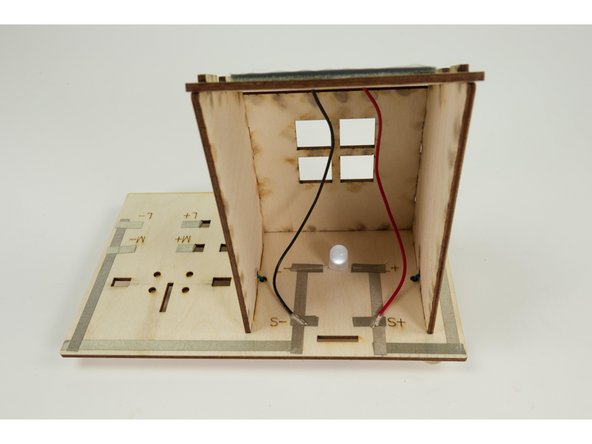 Cut another piece of Maker Tape and stick down the black (Negative) wire to the spot marked S-.