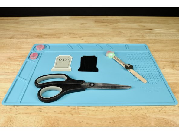 Cut out a tombstone and its corresponding silhouette from the template page you printed at the beginning.