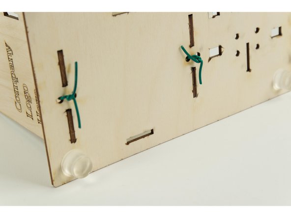 Insert the wall into the base, with the ends of the wire going into the two holes on each side of the wall.