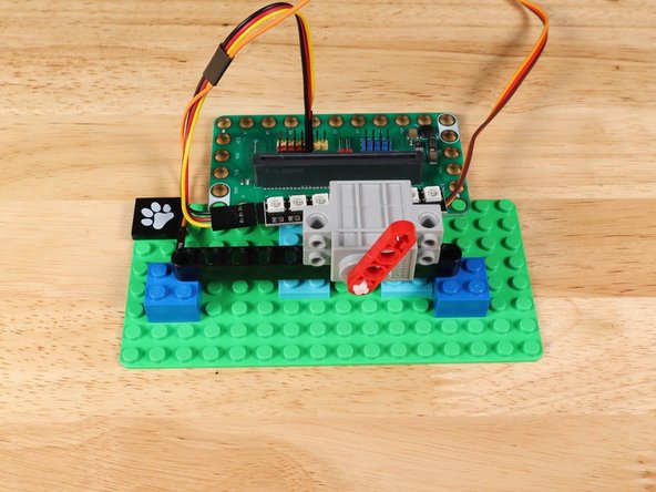 You can adjust the placement of the beam on the shaft, servo on the beam, and beam on the baseplate to make the assembly line up the way you want.