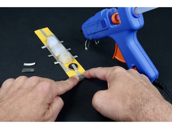 Press either the hook or the fuzzy loop portion of your chunk of conductive hook and loop over the tape loop and glue as shown in photo 3.