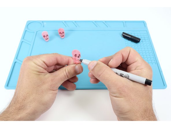 Optional: Use a fine tipped black permanent marker to color in the recessed details!