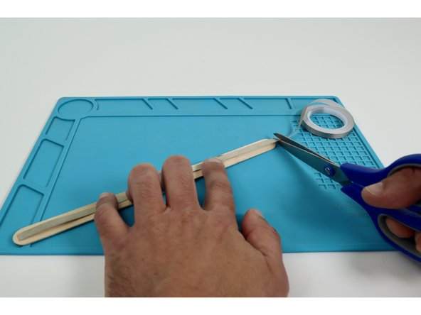 Measure and cut two separate Maker Tape pieces that are approximately the length of the wand handle you created.