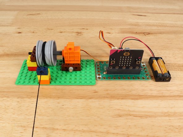 Plug in the battery pack to provide power to the servo and try pressing button A or B on the front of the micro:bit