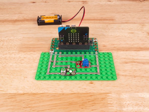 We'll connect our Potentiometer to Pin 1, Ground (GND), and 3.3v BUT! We're going to use the &quot;gutter&quot; between the LEGO baseplate studs so we can have two layers of tape that do not touch.