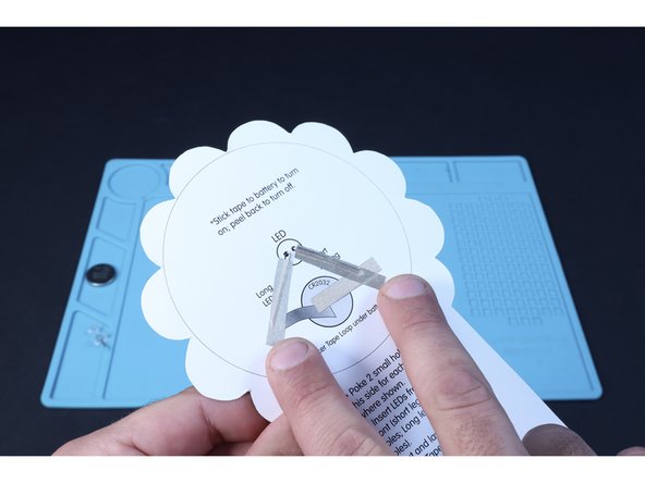 Peel and stick a Maker Tape path atop each of the LED legs where shown on the diagram. The short leg path should connect to the first path you placed.