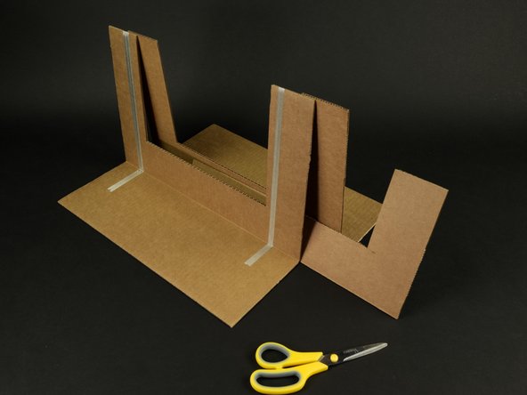 Slide the middle piece between the front and back piece. (Make sure you've folded the base on the front and back out 90 degrees so it can stand on its own.)