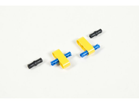 Assemble as shown. The long pins connect the two beams together.