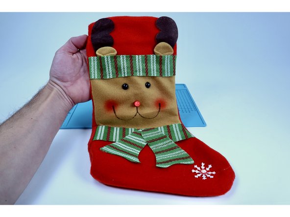 TIP: Oftentimes a circuit gets jostled out of working condition when the stocking is turned right-side-out. The LED may flicker or not work at all. If you encounter this issue, try pressing/firming up every connection point within the circuit where either an LED leg meets the tape OR where one piece of Maker Tape is connected to another!