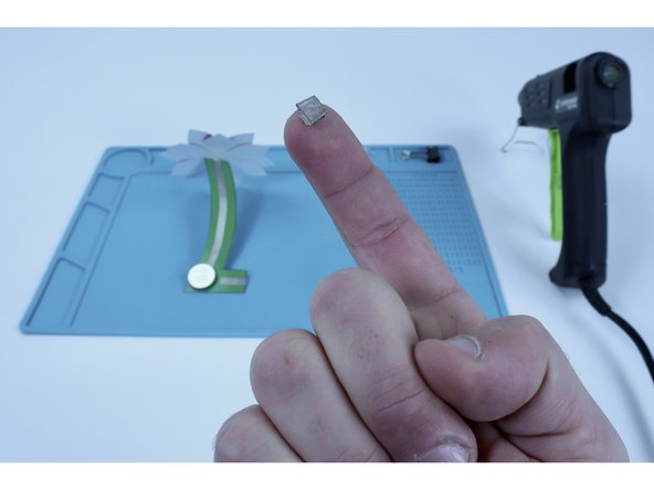 Use the remaining piece of Maker Tape to make another tape loop and place IT where shown in photo 3.