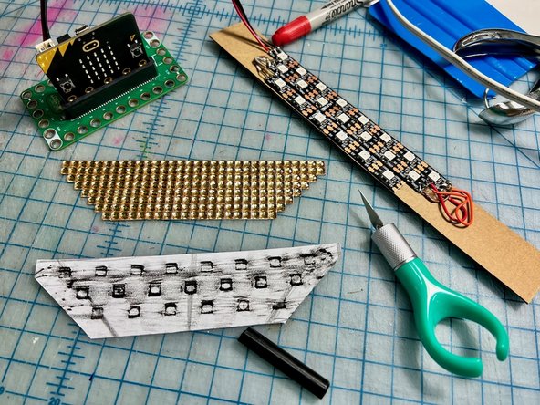 Make a rubbing of the LEDs with a crayon and a piece of printer paper. This will create a hole punching template for the correct spacing of the LEDs.