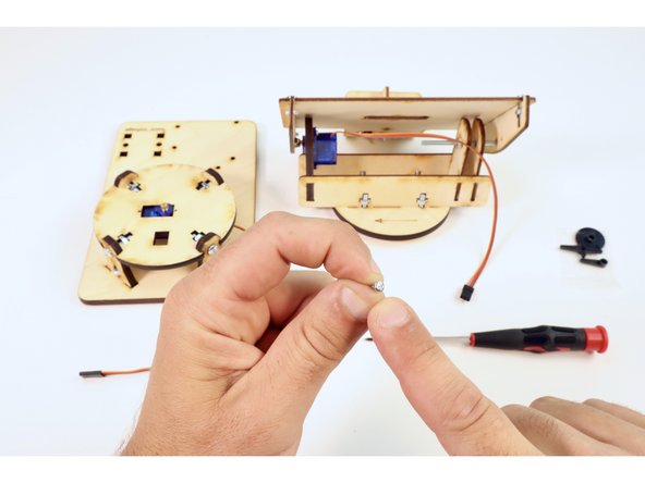 To join the pictured assemblies, first locate the last small screw from the servo bags.