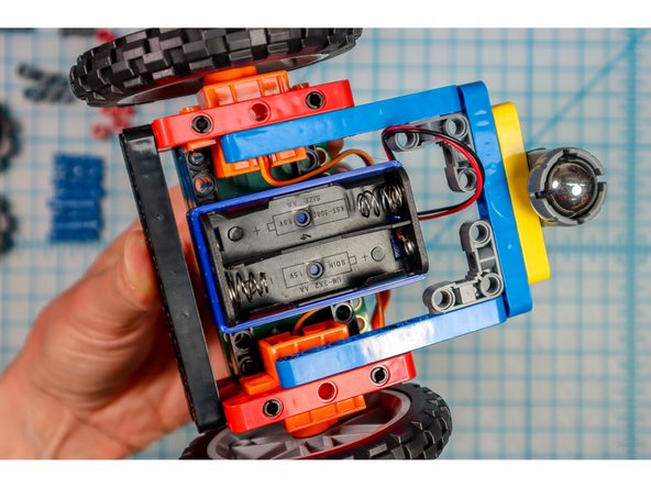 Place two pins in the center of each black beam as shown.