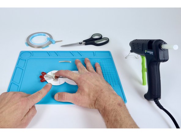 Stick battery atop the tape loop so that the positive (+) side faces UP.