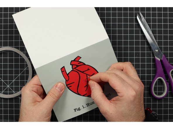 Use the safety pin (or paper clip) to poke holes through the front of the card.