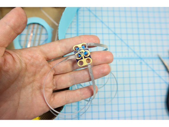 Thread three long pieces of Maker Tape through the top, middle, and bottom holes of the potentiometer making a good connection to each.