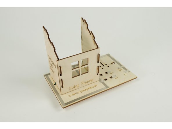 With the side walls in place you can now add the front wall of the house.