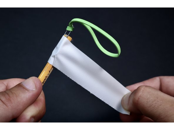 Tightly tape the paperclip to your pencil leaving about 1/4&quot;-1/2&quot; hanging off the end. Tight wraps are important here because the paperclip will be under considerable tension when launching.