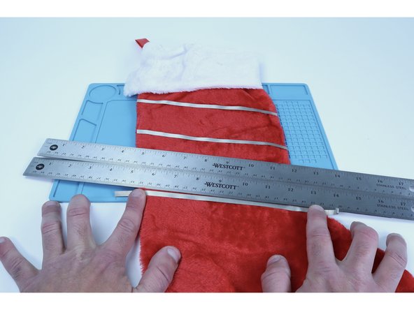 Lay the two rulers over the top of the last Maker Tape path you placed and,  just as you did to complete the first two-path stripes, use the lower edge to guide the placement of the next edge-to-edge Maker Tape path.