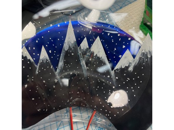 I added a layer of clear acetate painted with dots of silver to look like snow.