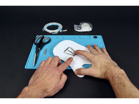 Stick battery atop the tape loop so that the positive (+) side faces UP.