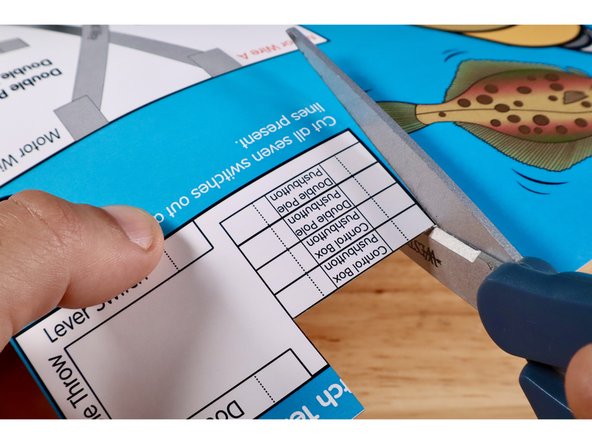 Cut and remove the two &quot;Control Box Pushbutton&quot; templates from the upper right corner of the Flat Fish project poster. Fold each on the two dotted lines.