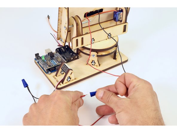 Twist  one wire nut onto the black wire bundle.