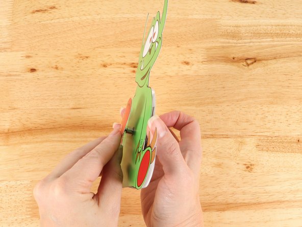 Add hot glue or  another square of double-sided tape onto the middle of the heart template, and then stick the heart to the top of the motor.