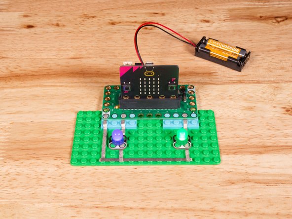 Connect the Negative (-) sides of the LEDs to a Ground (GND) hole on the Bit Board.