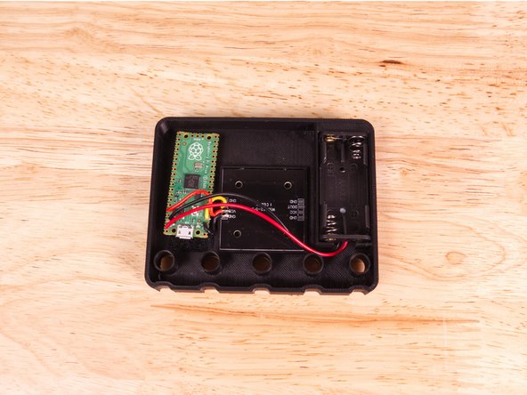 The 2AAA Battery Pack goes into the pocket on the opposite side of the microcontroller.