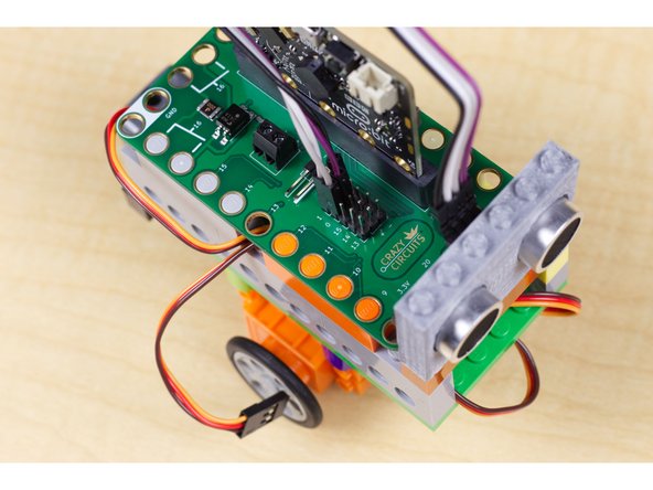 For the sensor you'll need to connect the trigger pin to Pin 0 on the Bit Board, then connect the  echo pin to Pin 1. Next connect VCC to any pin in the + column and Gnd to any pin in the - column. This will power the sensor and allow it to talk to the micro:bit through the Bit Board.