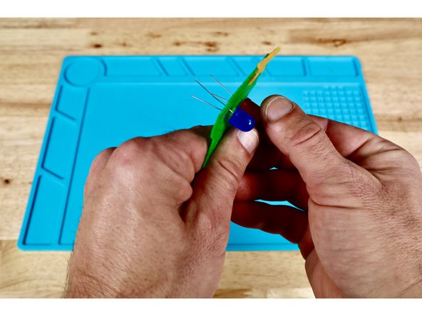 Use a pushpin to make a hole where each marked dot is located. There will be four holes in total.