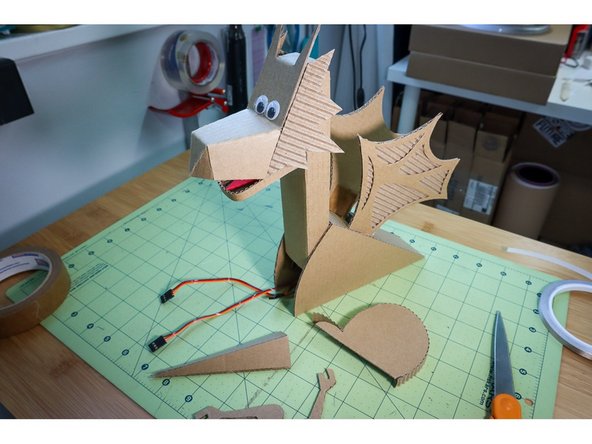 Glue the triangular shapes to the sides of the back.