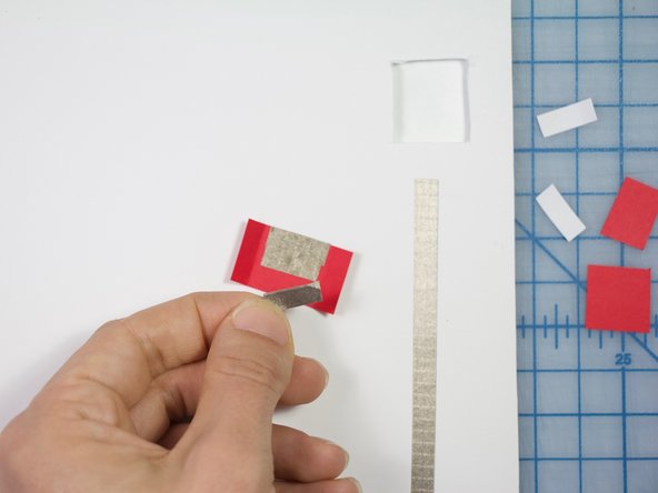 Cut small pieces of Maker Tape to cover the inside of the flap as shown.