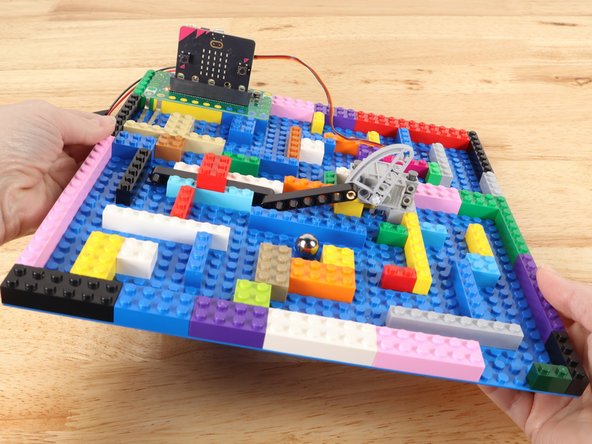 Get the ball bearing to the conductive tape to open the gate. Get the ball through the gate BEFORE the time runs out!