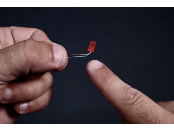 Find your LED and prepare it for addition to your shape's circuit pathways  by first locating the longest leg and making sure it's on the left when you hold the bulb and look at it from above. Now bend the legs away from you.