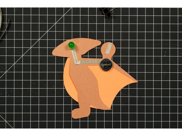 Place the battery so that bottom (negative) side is over the negative line of tape.