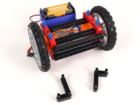 Remove both L-shaped beams and the 3 pins holding them in place.