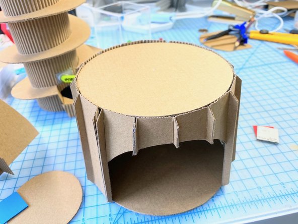 We glued a cardboard circle to the top and bottom of the base.