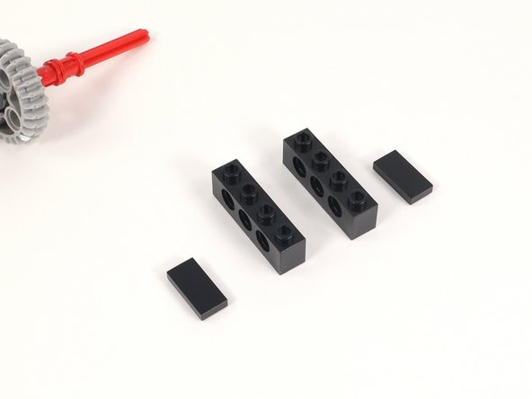 Add a 1x2 tile to the last two studs of a 1x4 brick with holes. You will need two of these.