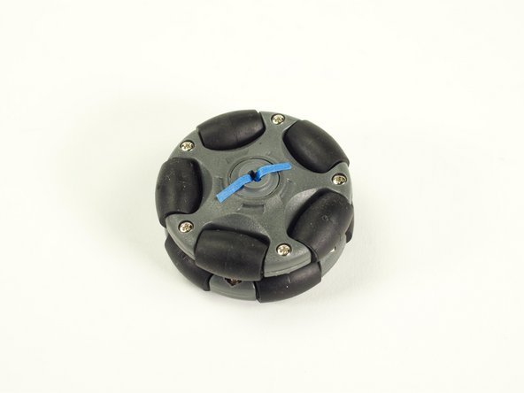 Cut a thin piece of tape (we used blue painter's tape) and stick one end down as shown.