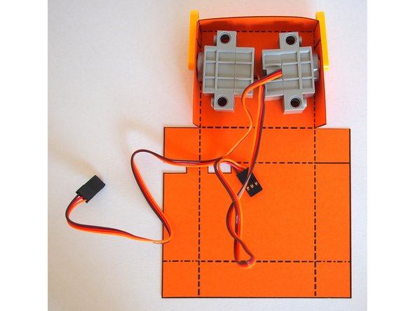 Attach the LEGO axle mounts to hold the servos in place.