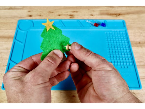 Each LED will have two wire &quot;legs&quot; that are difficult to push through the felt by themselves. To make this easier, make two dots for each LED where you want them to be; oriented vertically as shown in photo one.