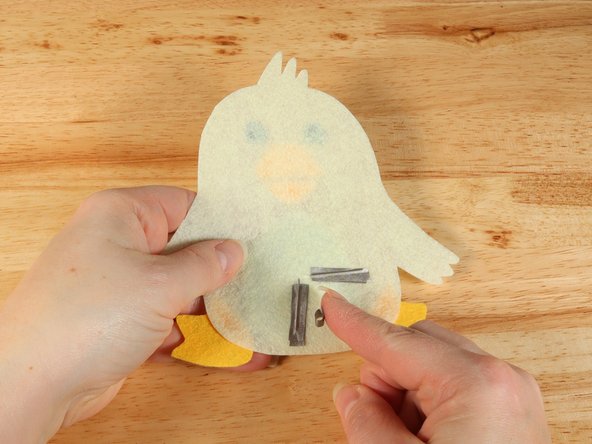 Make a loop of tape (sticky side out) using a short piece of Maker Tape, and stick it atop the end of the path coming from the short (Negative) LED leg.