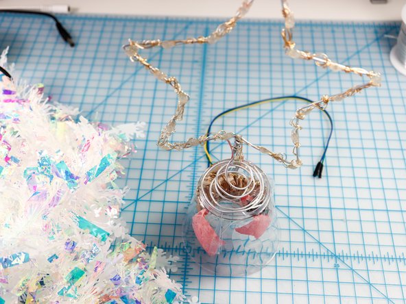 Wrap the garland around the cup and tape it in place.