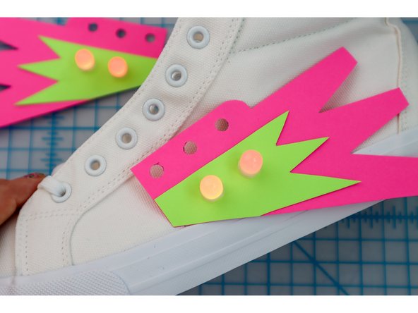 Unlace the shoes, then lace the shoes back up through the holes.