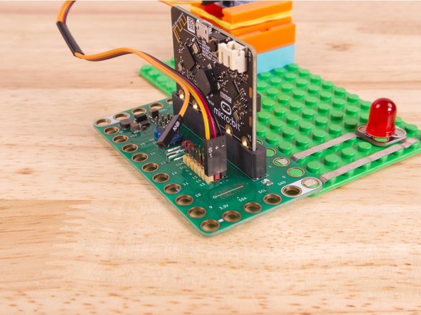 Now we'll connect the other end of the Ribbon Cable to the Capacitive Touch Sensor. S1 (Yellow) goes to IO, and then + (Positive) goes to VCC and - (Ground or Negative) goes to GND.