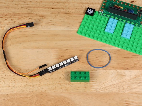 Attach the NeoPixel Strip to a LEGO brick with a rubber band.