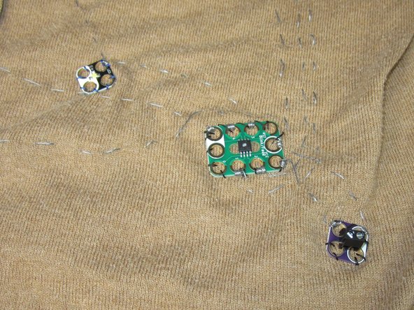 If you're only using 2-4 LEDs you can get away with using a CR2032 Coin Cell holder instead of the Screw Terminal + 2 AAA combo. This removes the need to sew a pocket onto your sweater to hide the battery pack in.