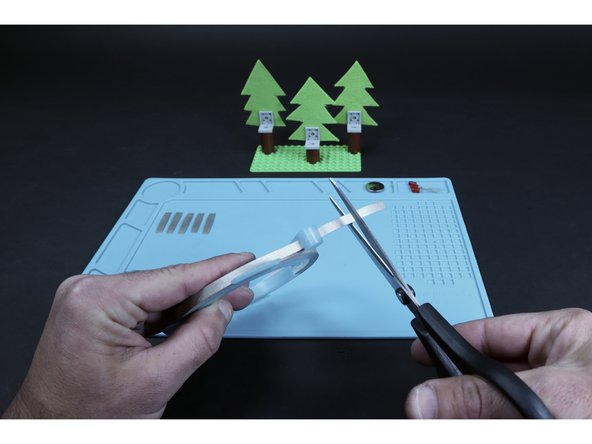 Begin by cutting (6) 2&quot; long Maker Tape segments that you will use to secure each LED in place with atop each of the three trees. These pieces of Maker Tape also begin the pathway system that will bring voltage to and from each LED.
